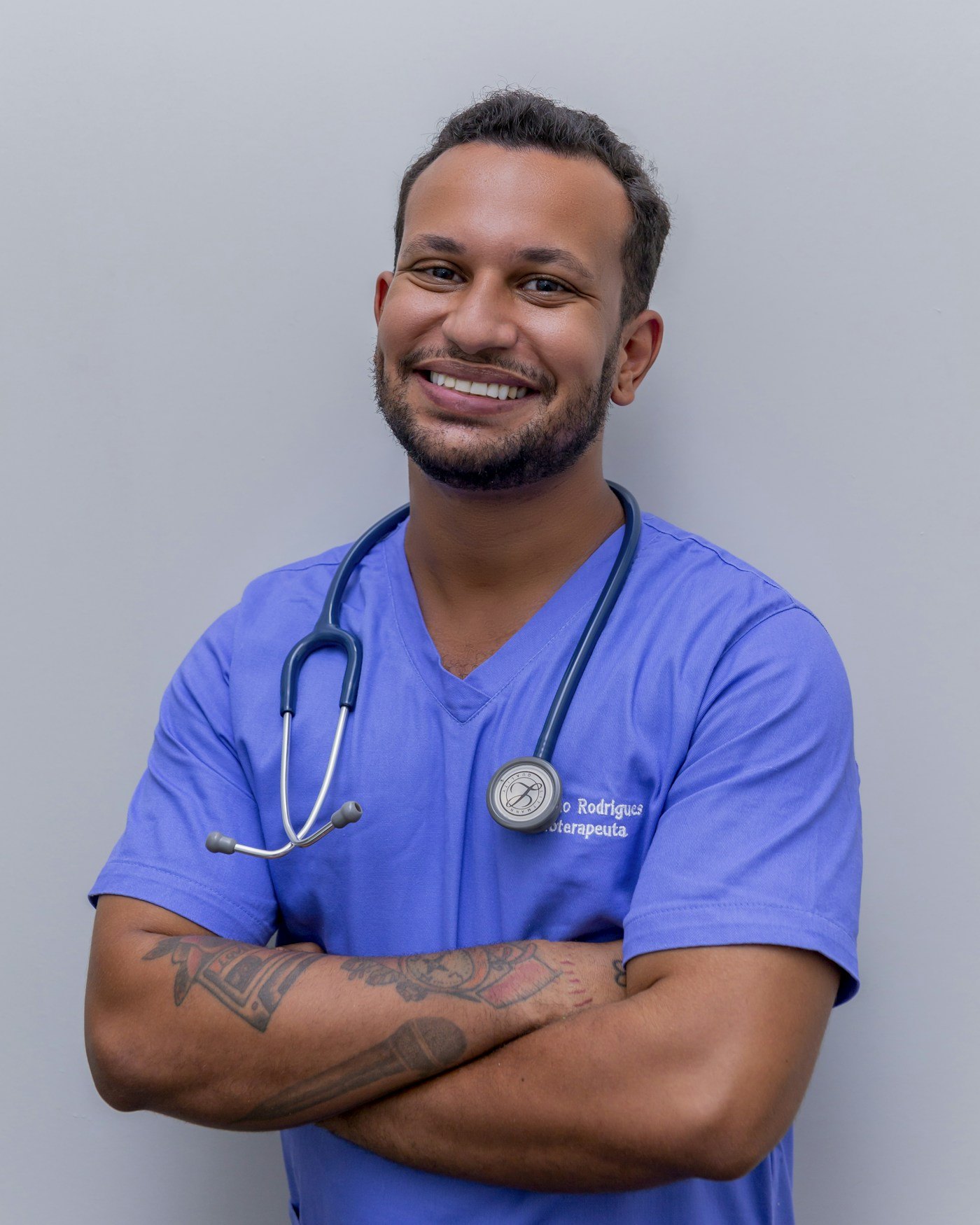 Smiling healthcare professional in blue scrubs with a stethoscope